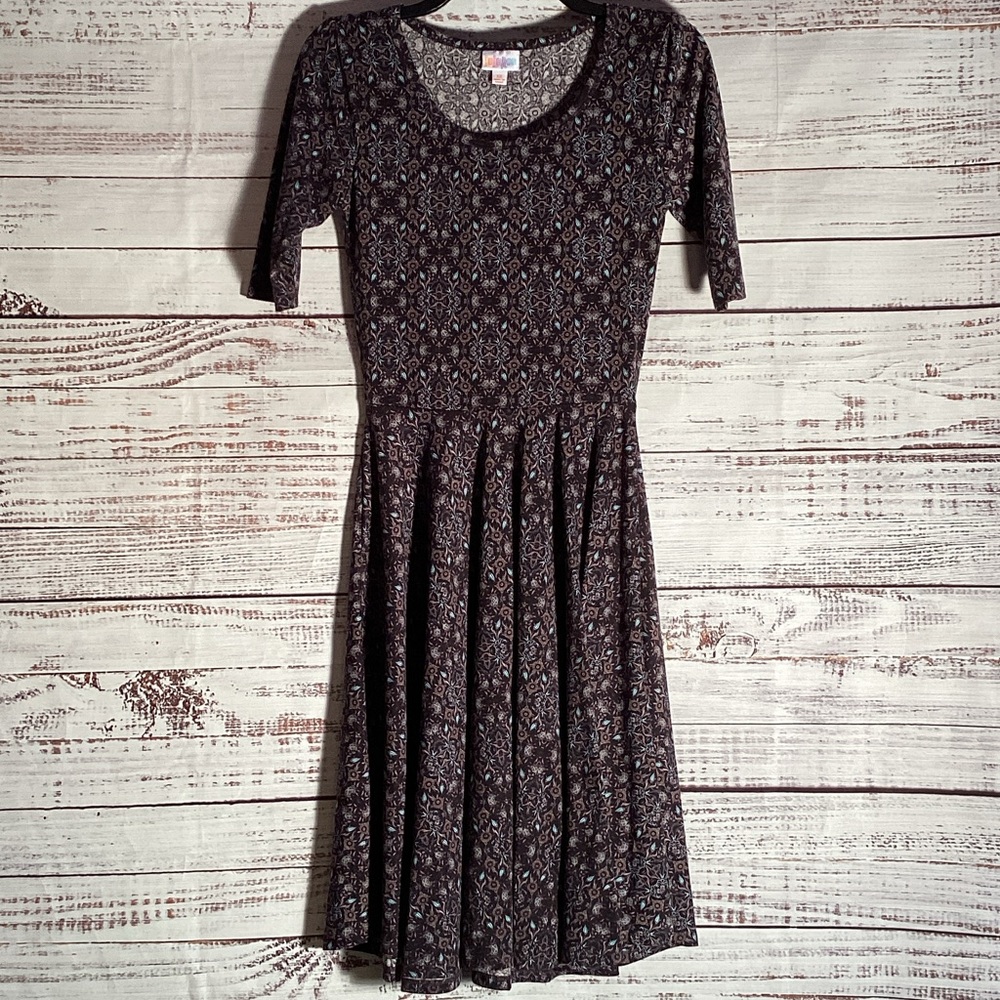 LuLaRoe Black Background with a tan & teal floral pattern.
